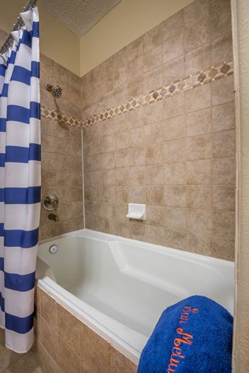 a bathroom with a tub and a shower curtain